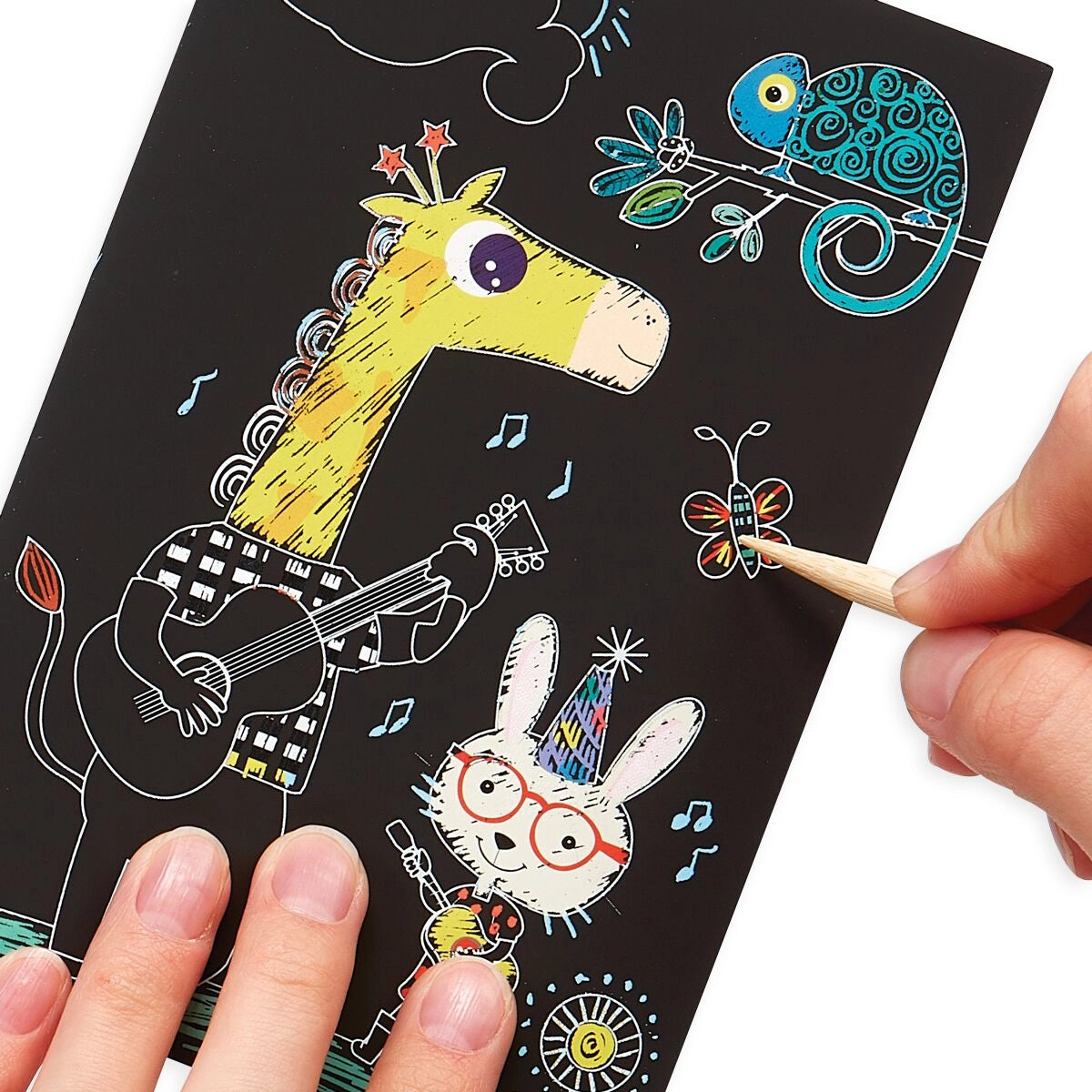 Scratching tool being used to color in an animal themed kit 