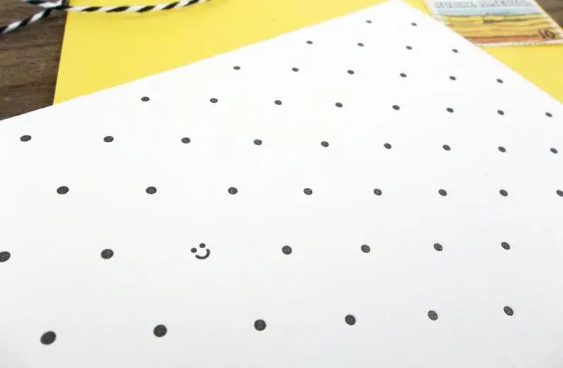 Close up view of black polka dot pattern and smiley face