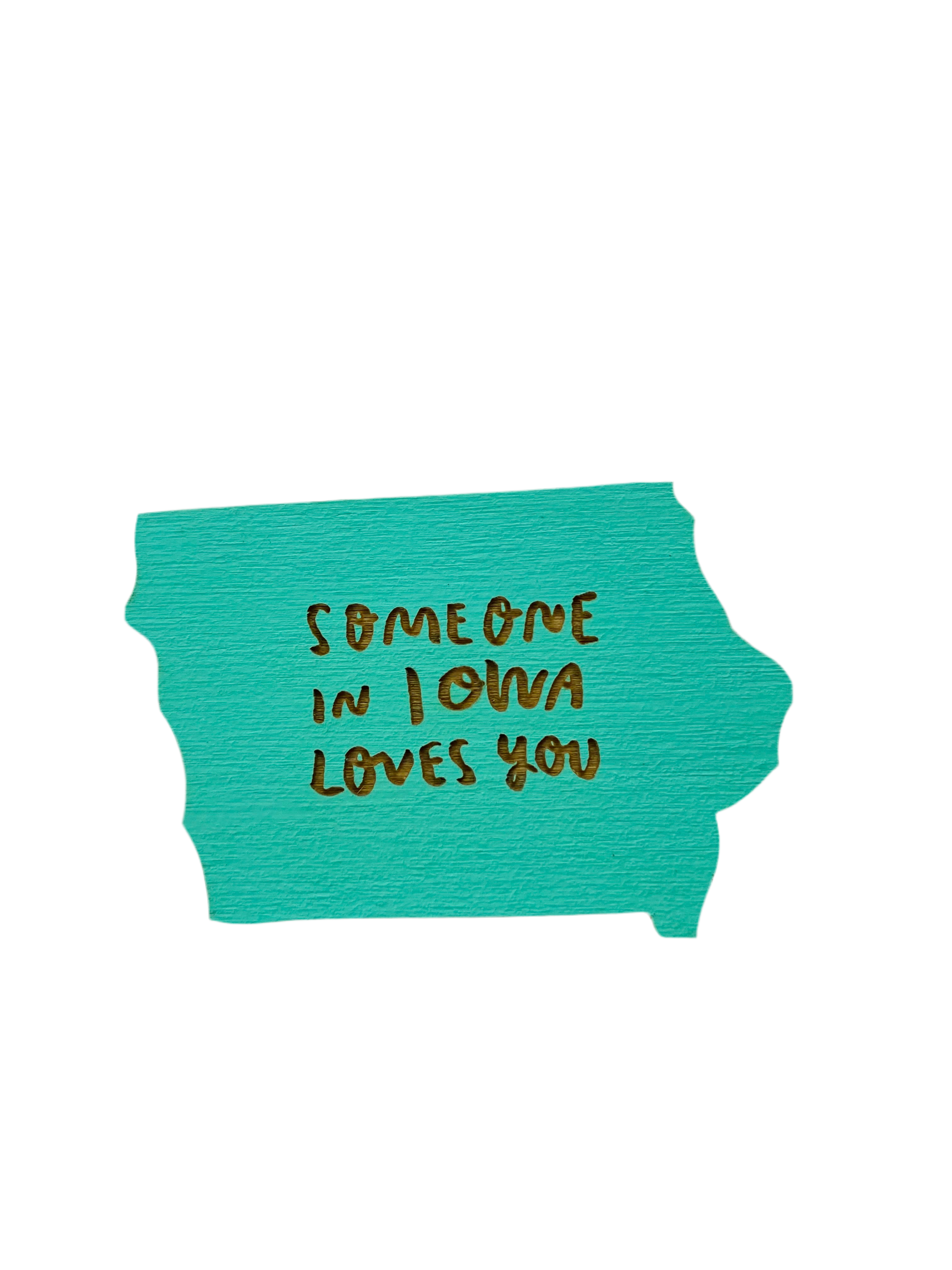 Iowa shaped aqua blue magnet. Laser cut into the magnet is the text “someone in Iowa loves you” 