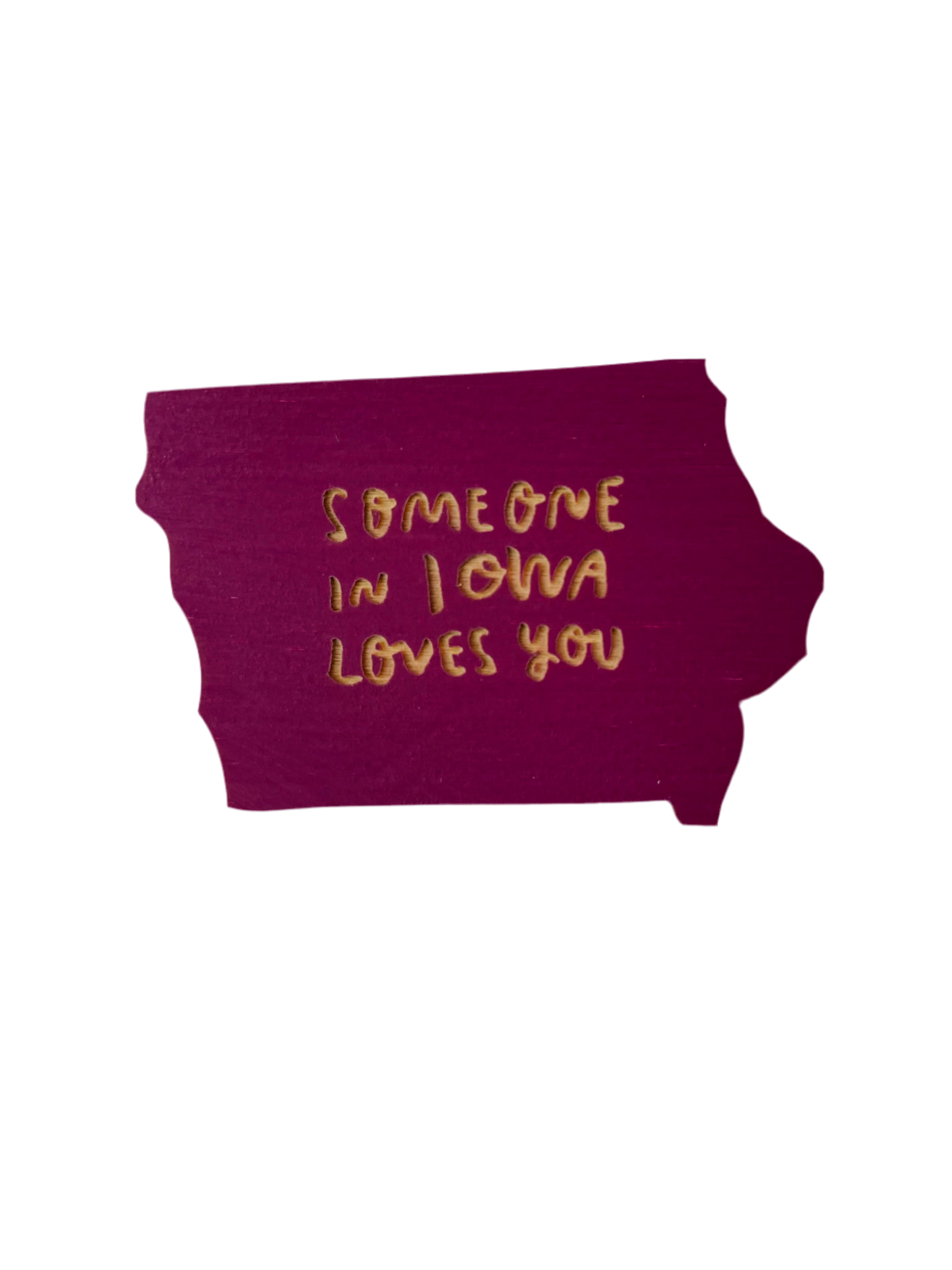 Iowa shaped purple magnet. Laser cut into the magnet is the text “someone in Iowa loves you” 