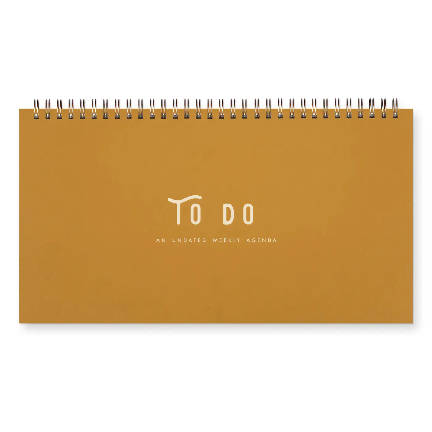 Front cover of top-spiral notebook. Mustard color with white text “to do, an undated weekly agenda” 