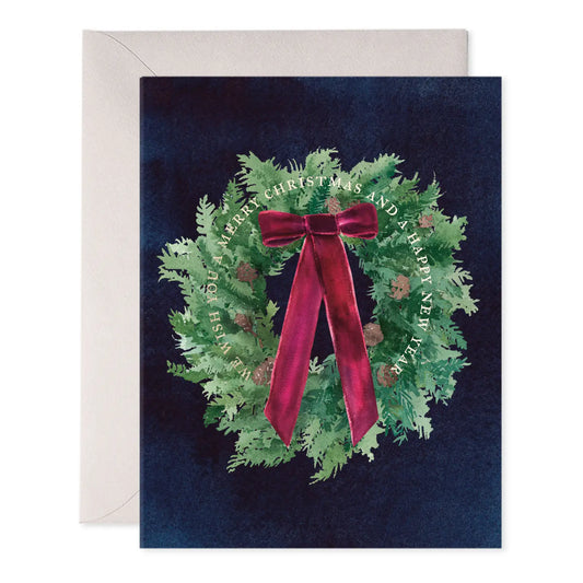 Christmas card with a wreath and red ribbon on a dark blue background