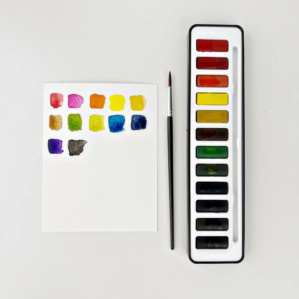 Another view of the watercolor palatte. Colors are painted on a white piece of paper. 