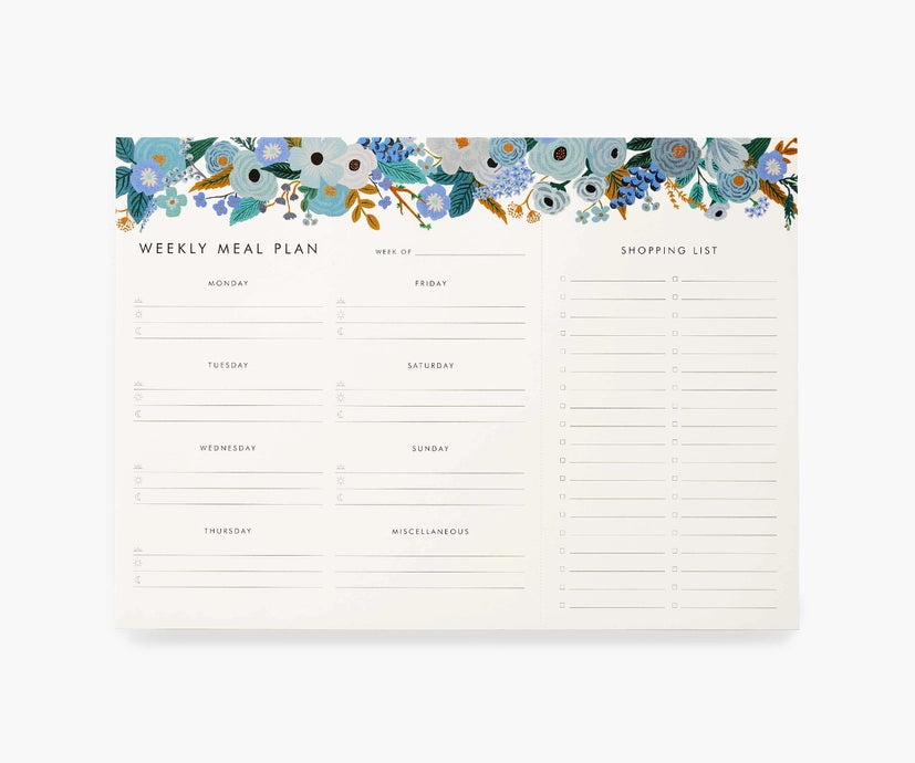 White notepad with blue flowers at the top. Black text reads "weekly meal plan" and has lines for each day of the week. Black text reads "shopping list" with lines for items. 