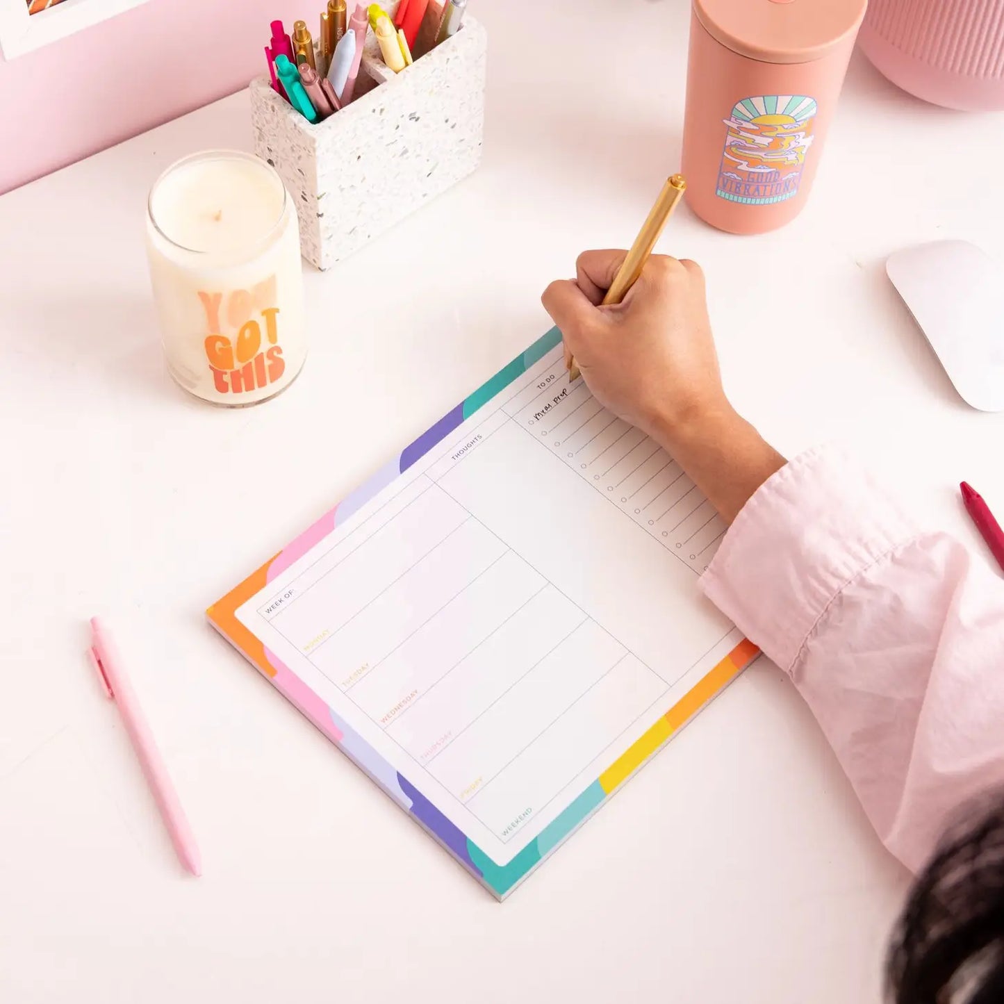 Person writing on the note pad