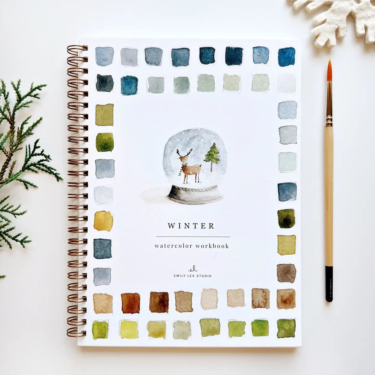 Watercolor workbook front cover with a snow globe design 