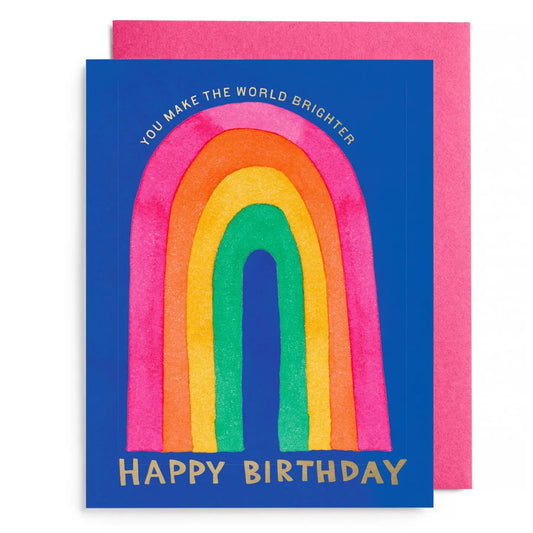 Birthday card with rainbow design and gold foil text on a blue background