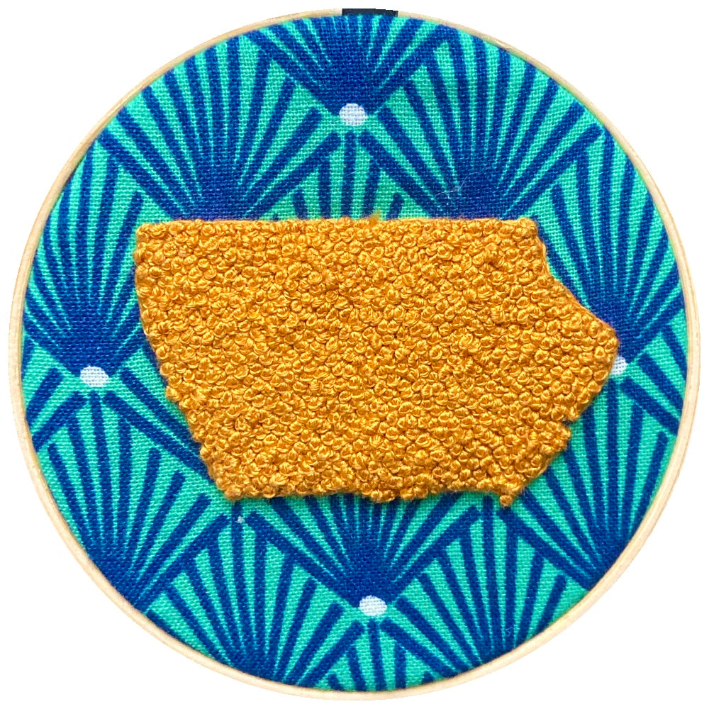 yellow Iowa embroidered on navy and green fabric