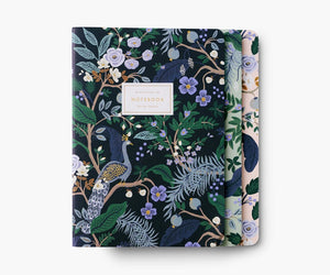 Set of three notebooks. One cover is black, one is light green, and one is white. All three are decorated with blue, green, gold, and purple flowers, leaves, and peacocks. 