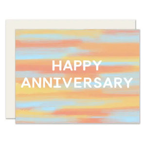 Blue, orange, and yellow gradient card. White text reads "happy anniversary" 