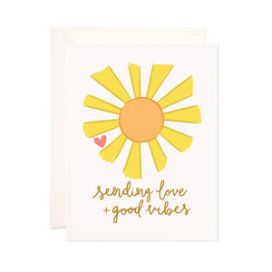 White card with a yellow and orange sun. Brown text reads "sending love and good vibes" 