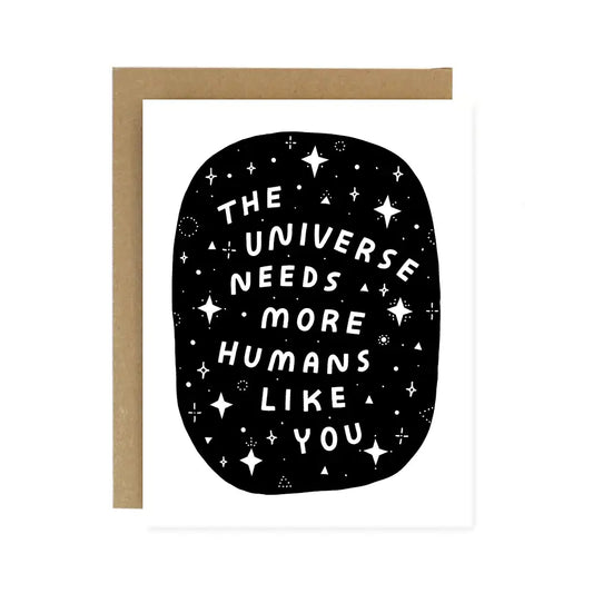 White card. Black background with white stars and white text reading "the universe needs more humans like you" 