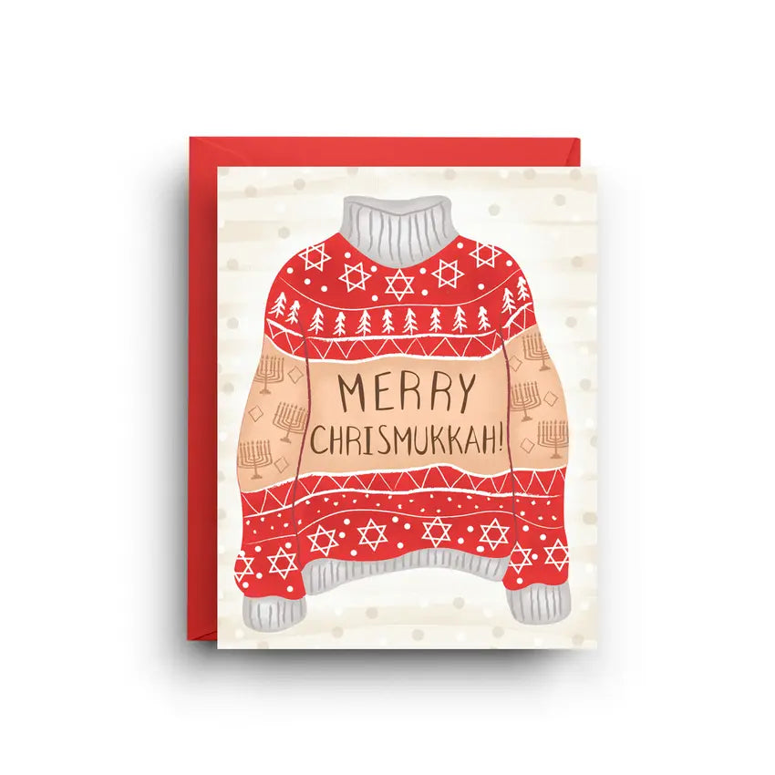 White card with rd, white, and brown holiday sweater, Brown text on the sweater reads "merry chrismukkah!" 