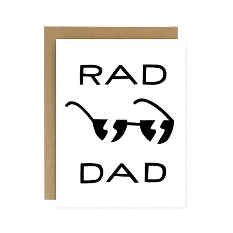 White card with black text reading "rad dad." Black ink drawing of sunglasses. 