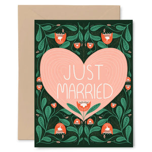 White card with black background. Pink heart with white text inside reading "just married." Around the heart there are green and red floral illustrations. 