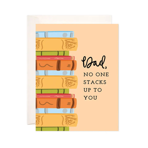 White card with an orange background and stacks of blue, orange, green, and red books. Black text reads "dad, no one stacks up to you"