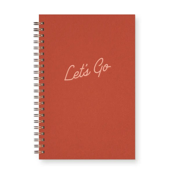 Red spiral-bound notebook with pink text reading "let's go"