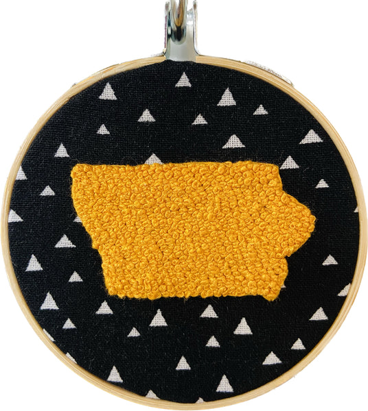 yellow Iowa embroidered on black and white fabric