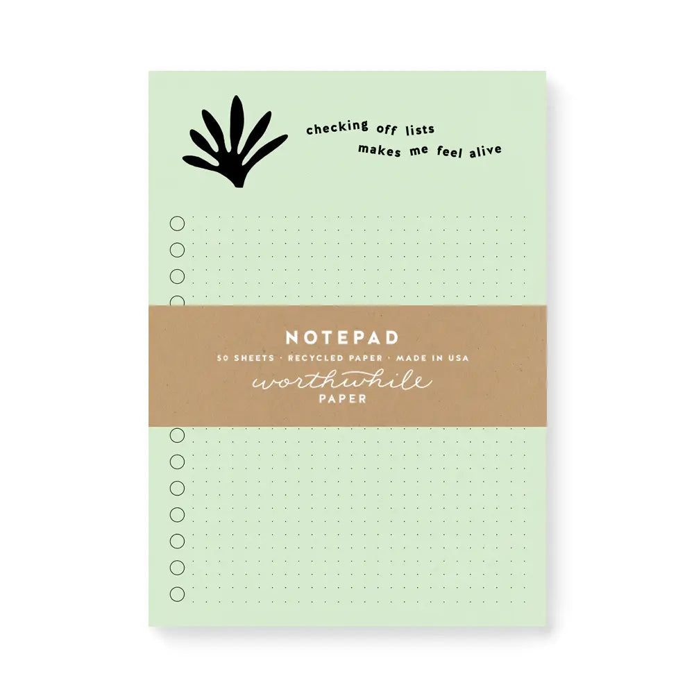 Light green notepad. Black text reads "checking off lists makes me feel alive"
