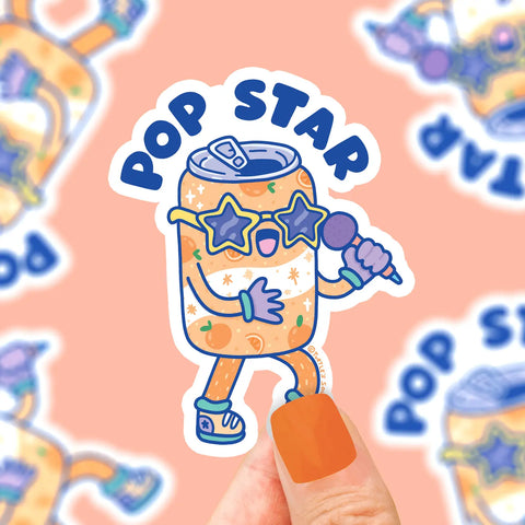 Orange soda can with yellow star sunglasses singing into a microphone. Blue text reads "pop star"