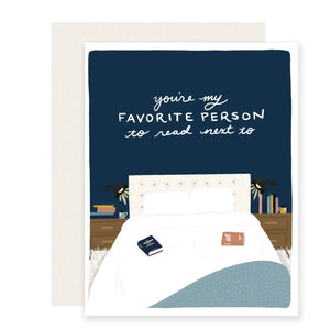 Navy card with white bed. White text reads "you're my favorite person to read next to"