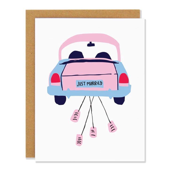 White card with pink and blue car with pink cans tied to the back. License plate has black text that reads "just married"