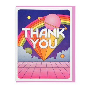 White card with navy background with an illustration of a rainbow and planet. White block letters with rainbow trails spell out "thank you" 