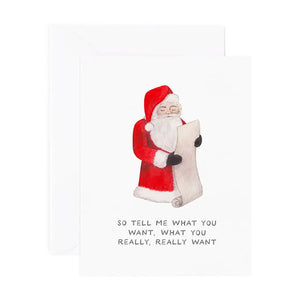 White card with red, white, and black drawing of Santa. Black text reads "so tell me what you want, what you really, really want"