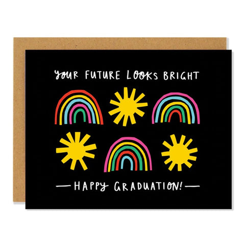 Black card with rainbows and suns. White text reads "your future looks bright; happy graduation." Inside of card is white.