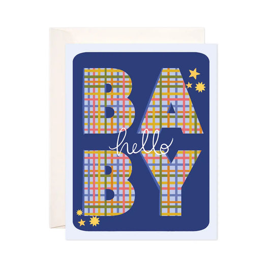 White card with blue background. Block letters filled in with green, red, yellow, and blue plaid spell out BABY. White text reads "hello." 