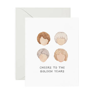 White card with hair styles of the Golden Girls. Black text reads "cheers to the golden years"