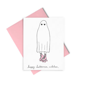White card featuring a ghost wearing pink roller skates. Black text reads "happy halloween, witches"