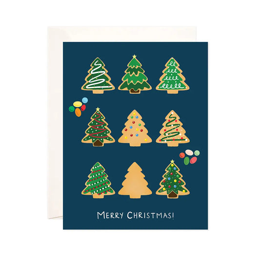 White card with navy background and illustrations of tree cut-out cookies decorated with green, red, and white icing. White text reads "merry christmas!"