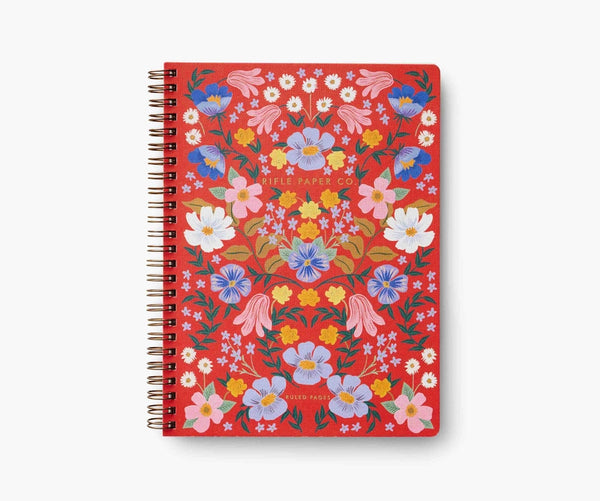 Cover of a red notebook with pink, blue, yellow, and white flowers. 