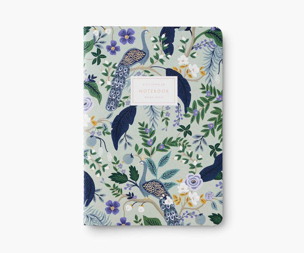 Light green notebook cover decorated with blue, green, gold, and purple flowers, leaves, and peacocks. 