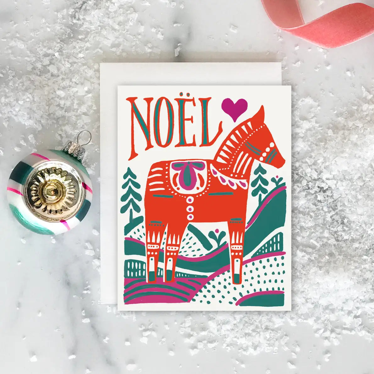 White text with red, green, and pink dala horse. Red and green text reads "noel"