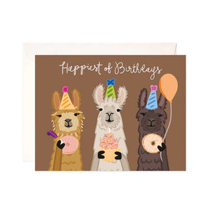 Brown card with three llamas holding donuts and cupcakes. White text reads "happiest of birthdays"