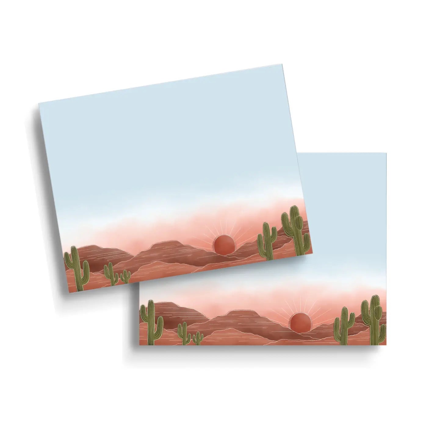 Pads of sticky note paper featuring a sunset over a desert landscape