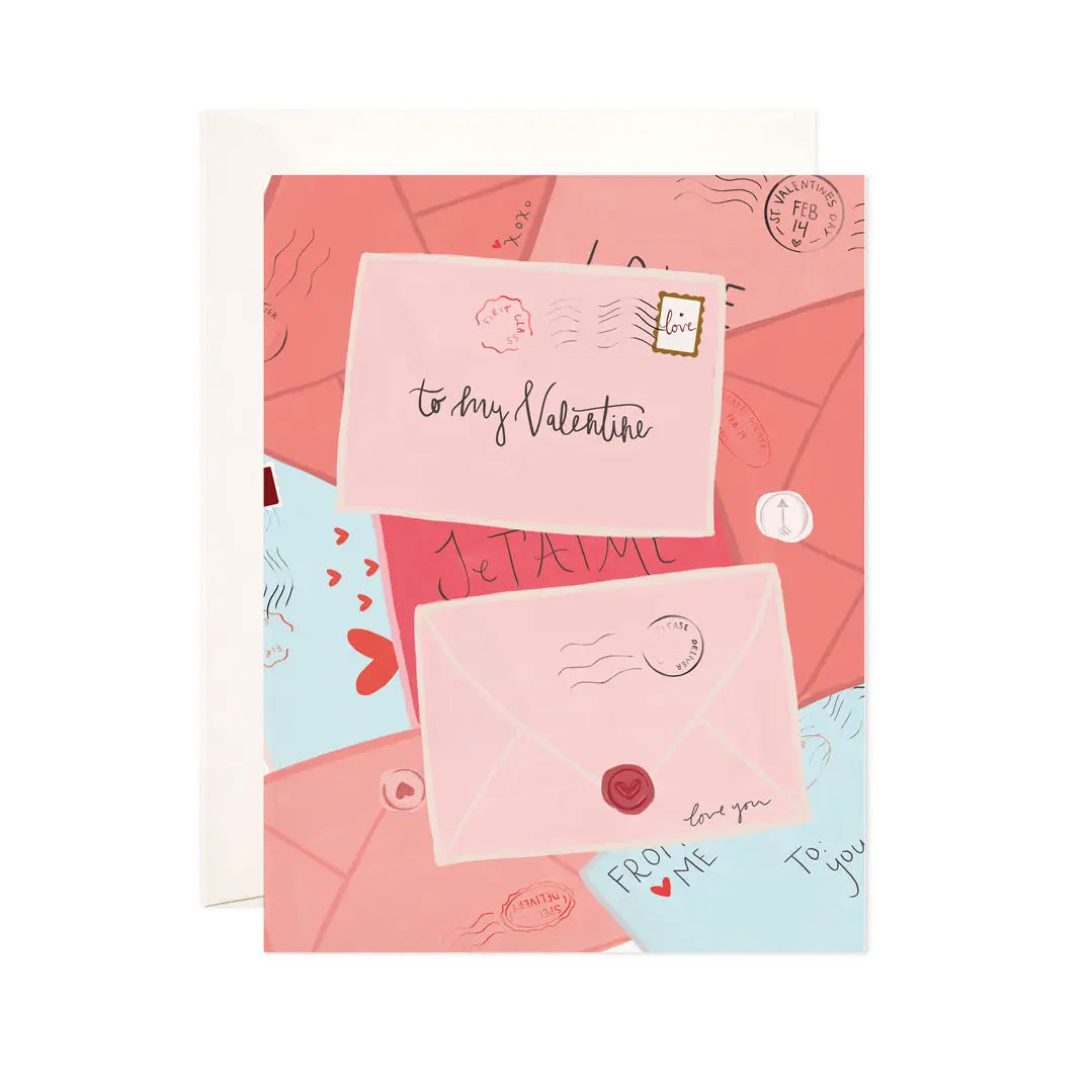 White card with letters in shades of pink and blue. Black text on one letter reads "to my valentine" 
