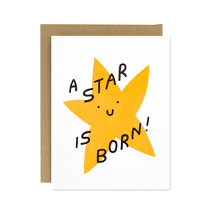 White greeting card. Yellow star with black smiley face. Black text "a star is born!"