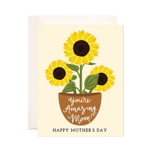 White greeting card with cream background. Illustration of sunflowers in a pot. Text “you’re amazing mom! Happy Mother’s Day” 